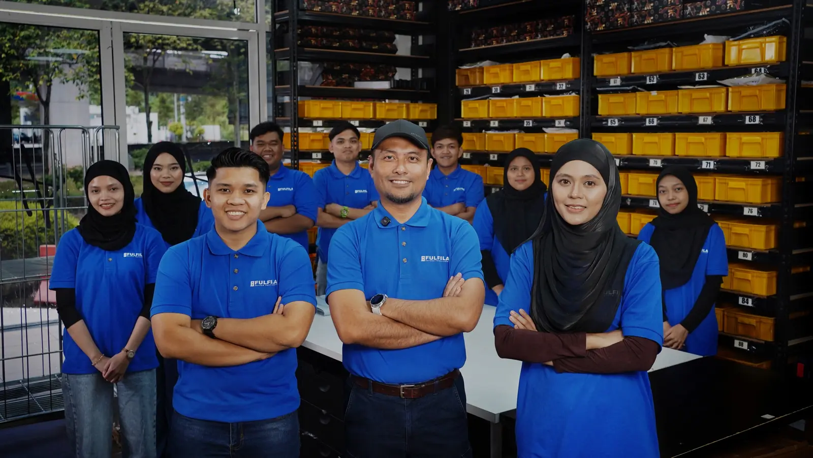 The FULFILA team in blue FULFILA shirts at the warehouse in Shah Alam